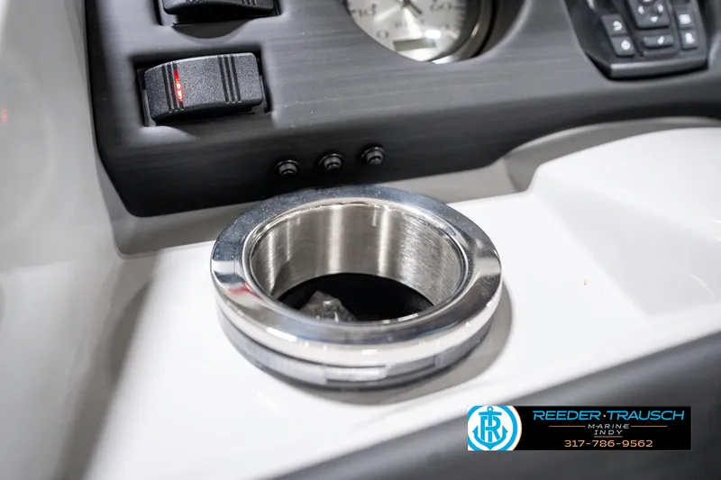 Slide: The Image of 2025 Bennington 23 S CRUISE dashboard with cup holder and controls. - 39