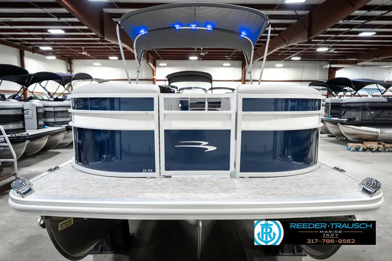 Slide: The Image of 2025 Bennington 23 S Cruise pontoon boat in showroom with blue accents. - 5