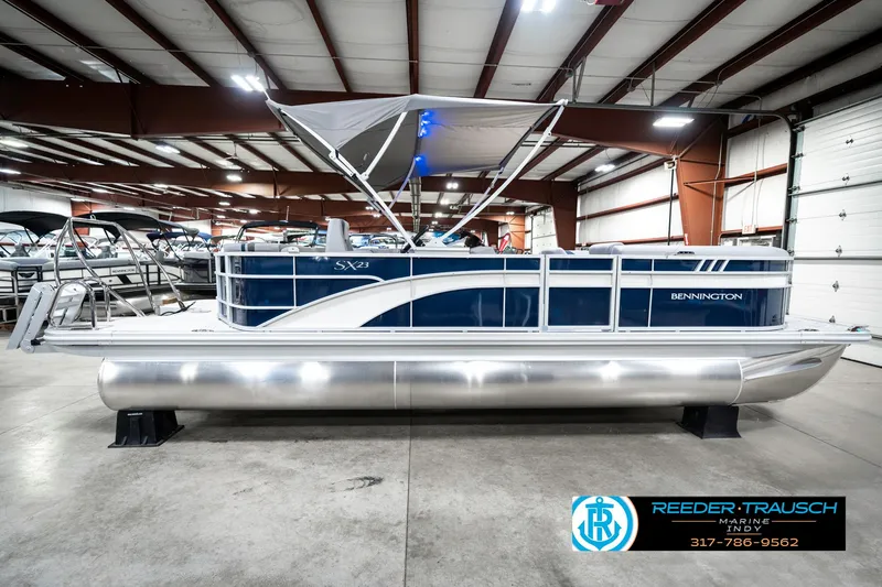 Slide: The Image of 2025 Bennington 23 S Cruise pontoon boat in showroom, side view. - 7