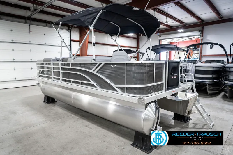 Slide: The Image of 2025 Bennington 21 SS pontoon boat in showroom with canopy and sleek design. - 10