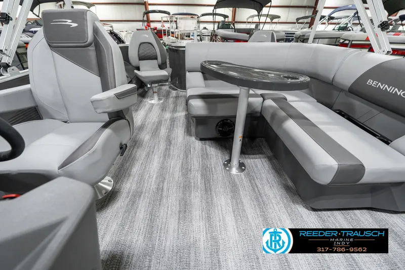 Slide: The Image of 2025 Bennington 21 SS boat interior with gray seating and table, showcasing modern design. - 17