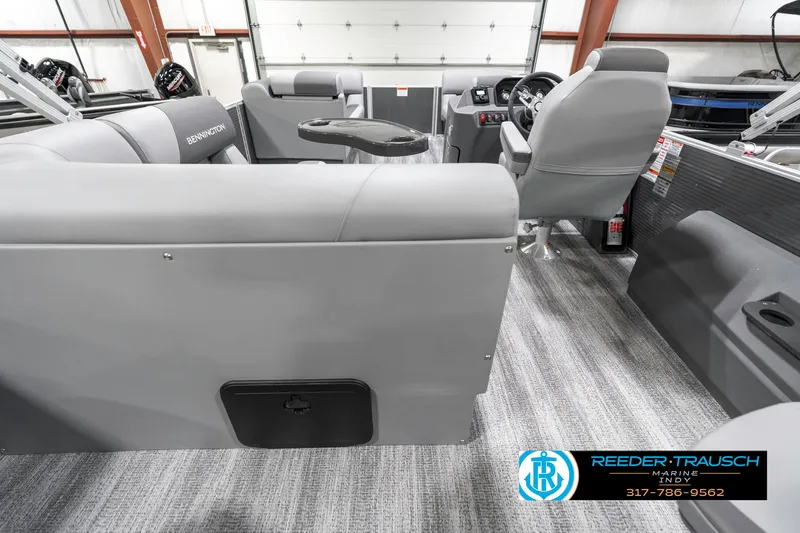 Slide: The Image of 2025 Bennington 21 SS boat interior with gray seating and modern dashboard. - 19