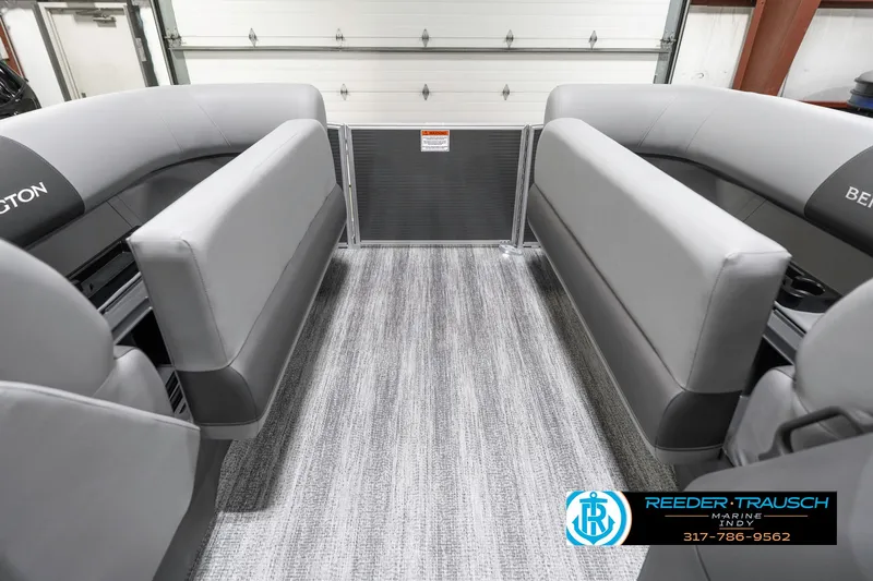Slide: The Image of 2025 Bennington 21 SS interior with gray seating and carpet, showcased in a showroom. - 22