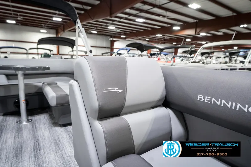 Slide: The Image of 2025 Bennington 21 SS pontoon boat interior with gray seating in showroom. - 23