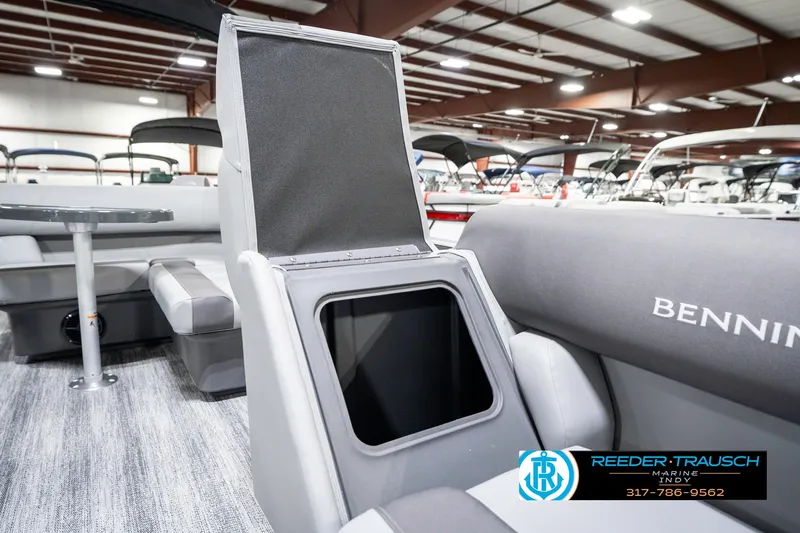 Slide: The Image of 2025 Bennington 21 SS boat interior with open storage compartment in showroom. - 24