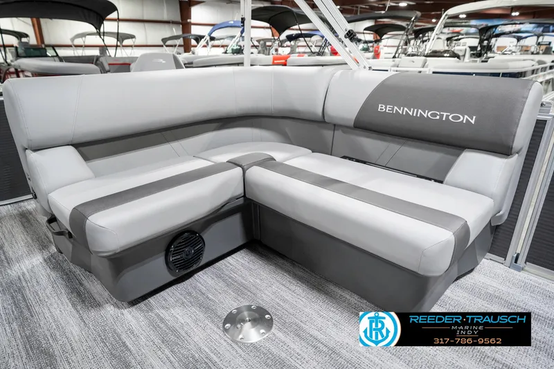 Slide: The Image of 2025 Bennington 21 SS pontoon boat interior with gray seating and logo. - 26