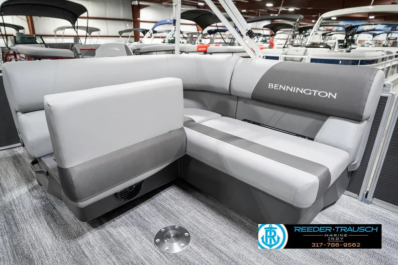 Slide: The Image of 2025 Bennington 21 SS pontoon boat interior with gray seating in showroom. - 27