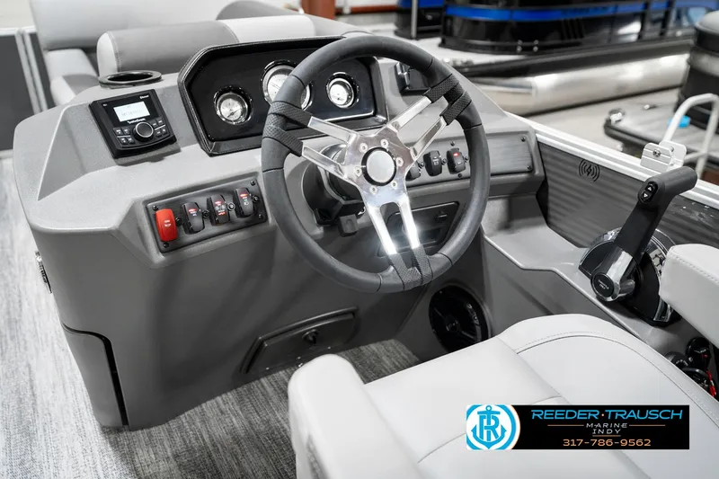 Slide: The Image of 2025 Bennington 21 SS boat dashboard with steering wheel and control panel. - 35