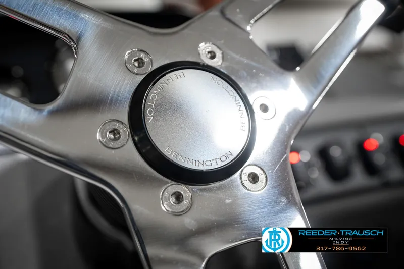 Slide: The Image of Steering wheel of 2025 Bennington 21 SS boat, featuring sleek metallic design. - 36