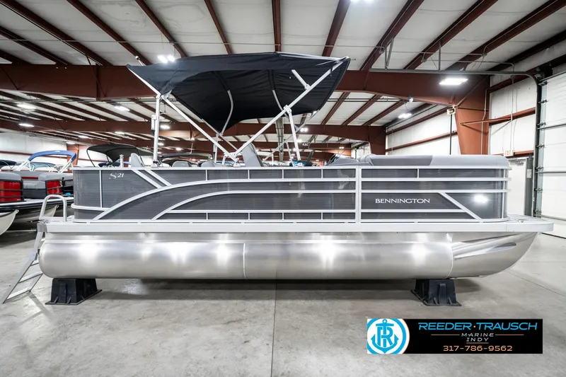 Slide: The Image of 2025 Bennington 21 SS pontoon boat in showroom, featuring sleek design and modern amenities. - 7