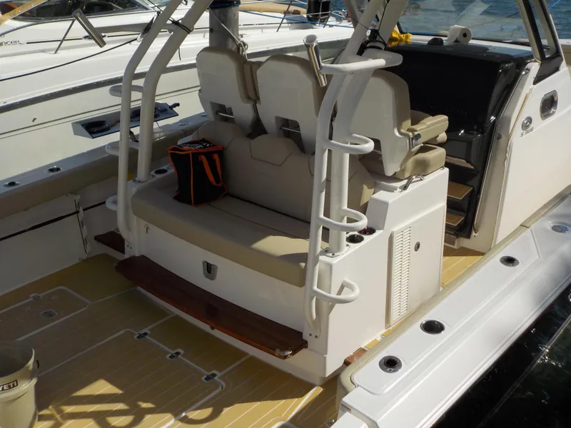 Slide: The Image of 2019 Pursuit S 368 boat interior with seating and storage compartments. - 2