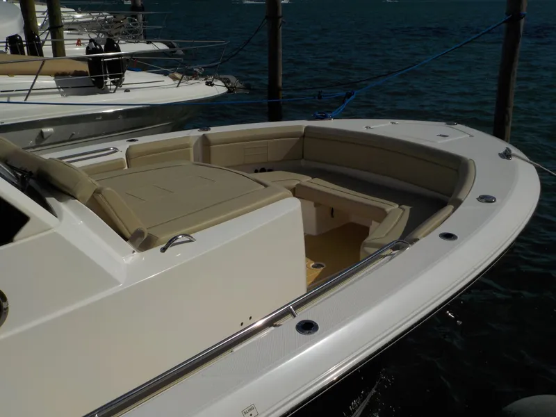 Slide: The Image of 2019 Pursuit S 368 boat with spacious seating, docked on calm water. - 3