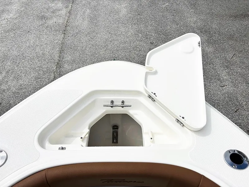 Slide: The Image of 2025 Pioneer 180 Islander boat with open storage compartment on deck. - 12
