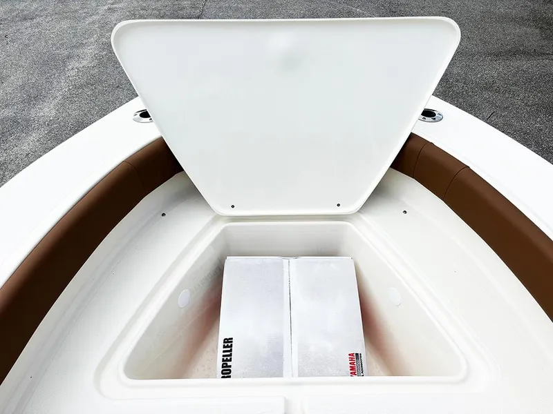 Slide: The Image of Open storage compartment on 2025 Pioneer 180 Islander boat, showing interior space. - 15