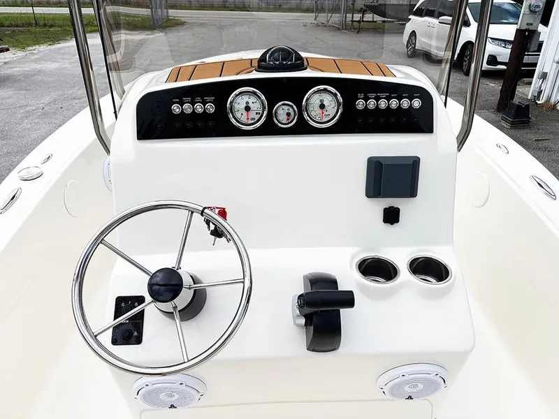 Slide: The Image of 2025 Pioneer 180 Islander boat dashboard with steering wheel and gauges. - 19
