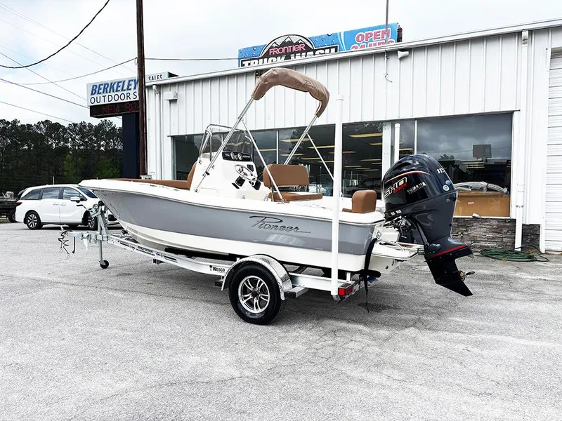 Slide: The Image of 2025 Pioneer 180 Islander boat on trailer outside dealership. - 2