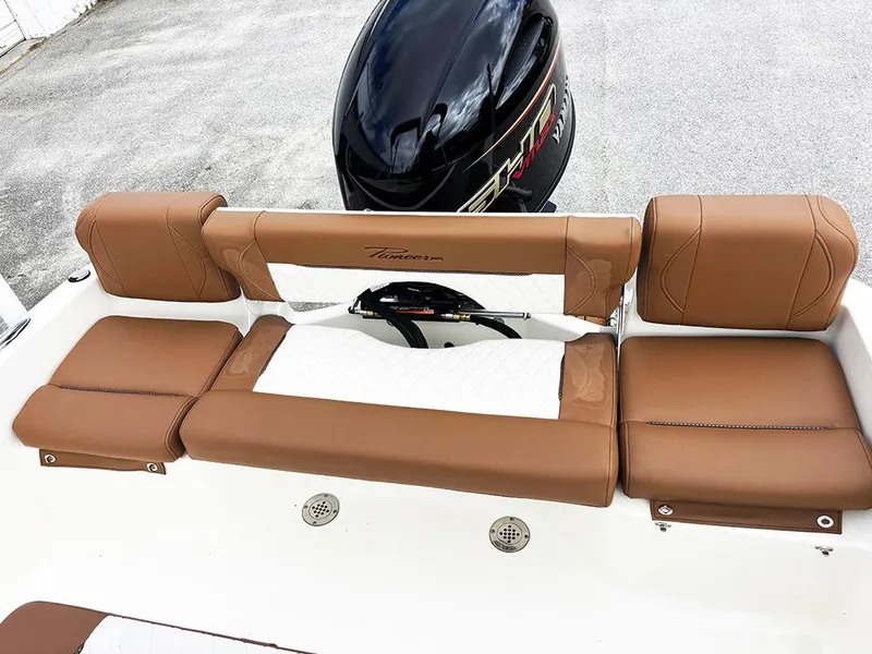 Slide: The Image of 2025 Pioneer 180 Islander boat with brown and white seating, featuring a sleek outboard motor. - 20