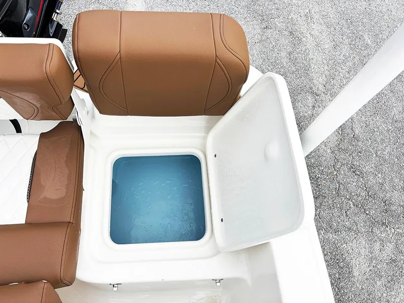 Slide: The Image of 2025 Pioneer 180 Islander boat with open storage compartment and brown seating. - 21