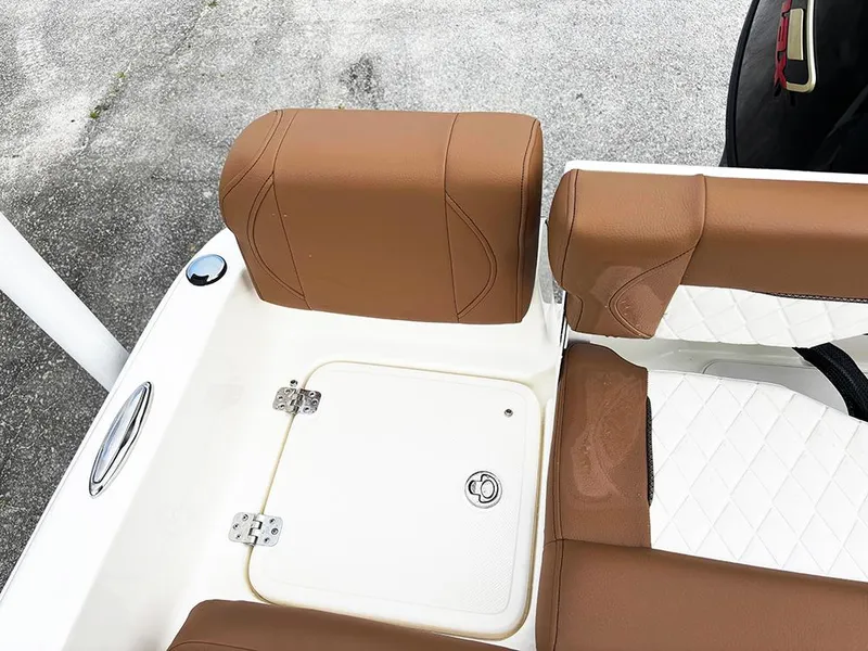 Slide: The Image of 2025 Pioneer 180 Islander boat seating with brown cushions and storage compartment. - 24