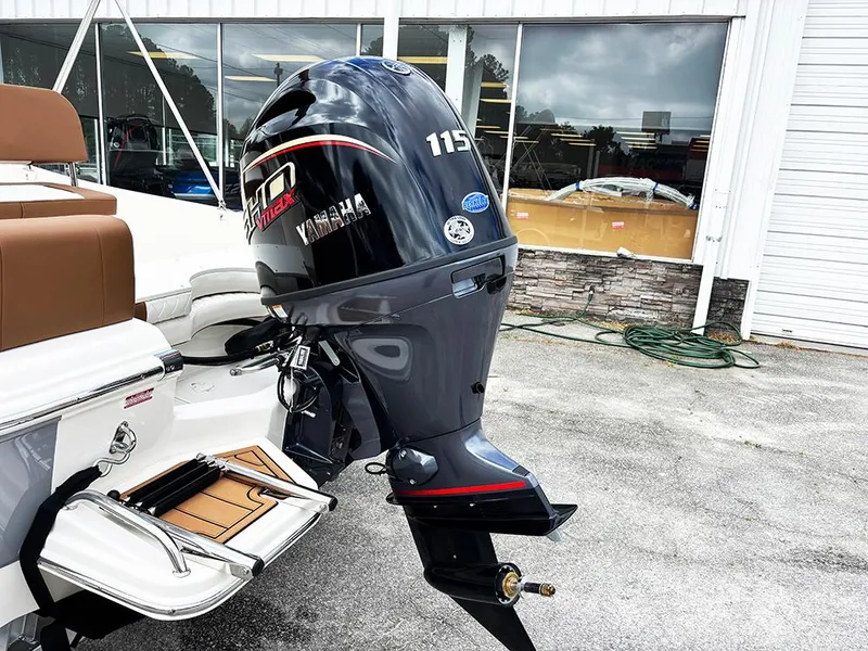 Slide: The Image of 2025 Pioneer 180 Islander boat with Yamaha 115 outboard motor, parked outside a showroom. - 25
