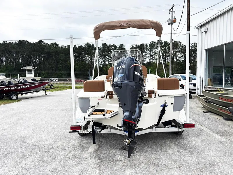 Slide: The Image of 2025 Pioneer 180 Islander boat with Yamaha 115 engine, parked outdoors. - 7
