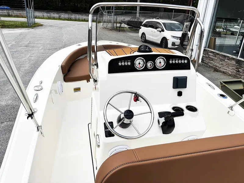 Slide: The Image of 2025 Pioneer 180 Islander boat interior with steering wheel and dashboard controls. - 9