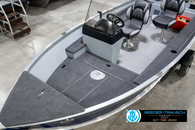 Slide: The Image of 2025 Lund 1600 Fury boat interior with seating and steering console. - 10