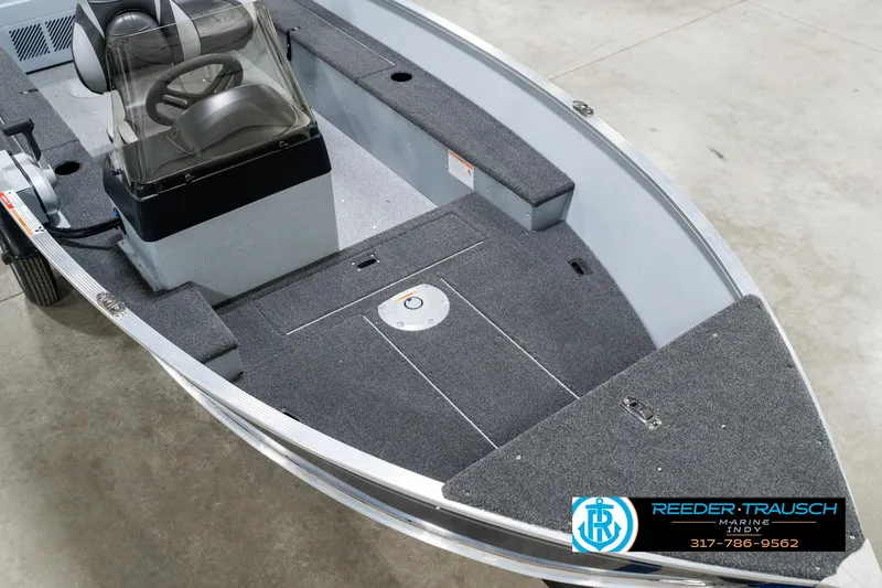 Slide: The Image of 2025 Lund 1600 Fury boat interior with seating and carpeted deck. - 11