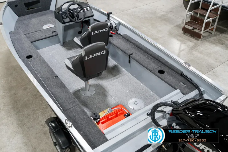 Slide: The Image of 2025 Lund 1600 Fury boat interior with dual seats and steering console. - 13