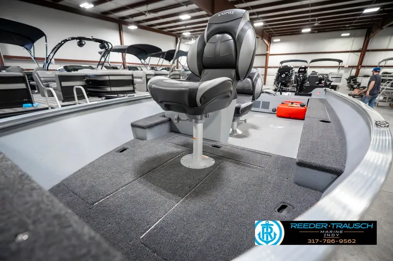 Slide: The Image of 2025 Lund 1600 Fury boat interior with seating, showcased in a showroom. - 18
