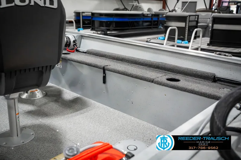 Slide: The Image of 2025 Lund 1600 Fury boat interior with seating and storage, showcased at Reeder-Trausch Marine. - 22