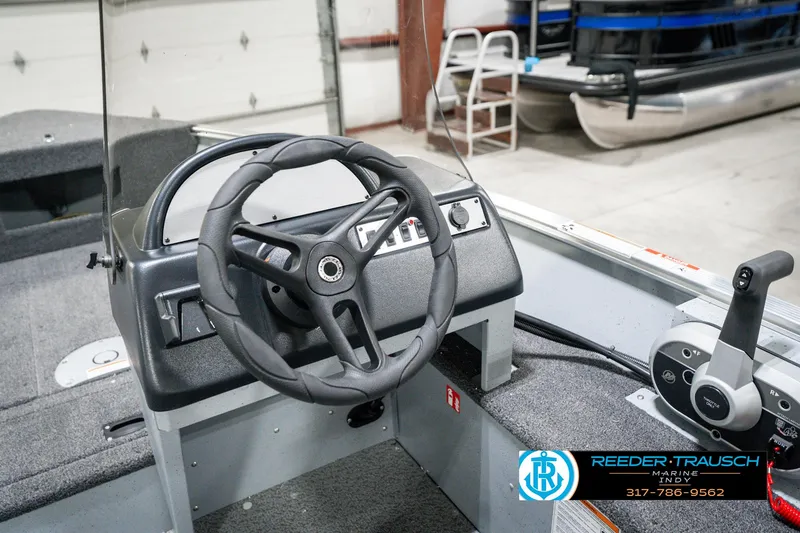 Slide: The Image of 2025 Lund 1600 Fury boat interior with steering wheel and control panel. - 26