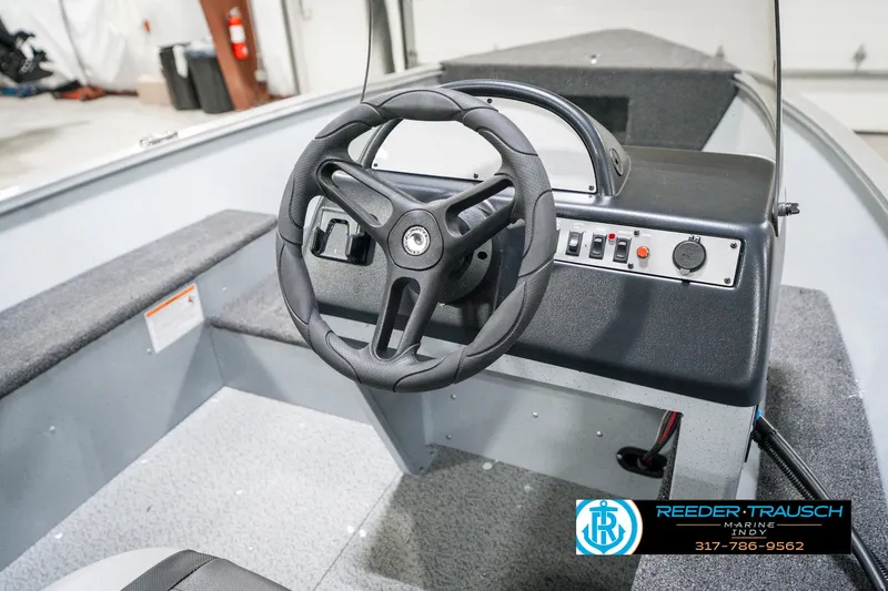 Slide: The Image of 2025 Lund 1600 Fury boat interior with steering wheel and control panel. - 27