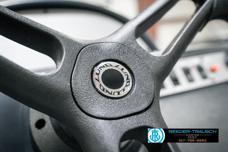Slide: The Image of Steering wheel of 2025 Lund 1600 Fury boat, featuring brand logo. - 28