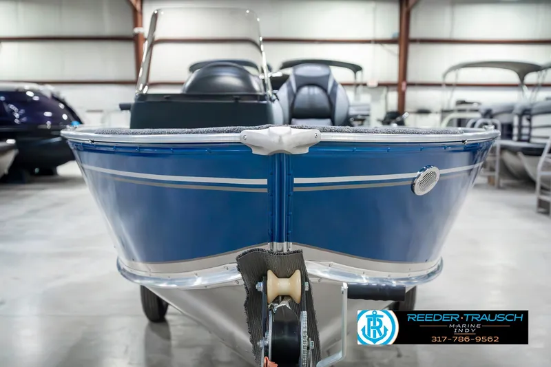 Slide: The Image of 2025 Lund 1600 Fury boat in showroom, blue exterior, front view. - 3
