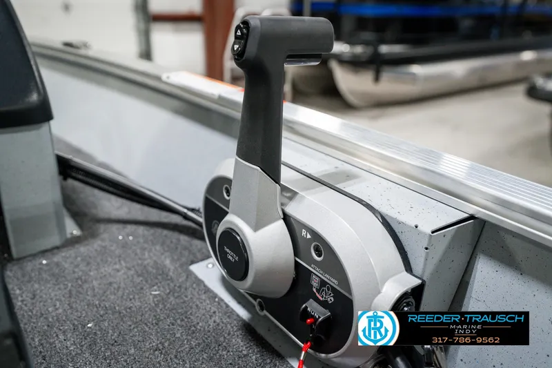 Slide: The Image of 2025 Lund 1600 Fury boat throttle control in a marine setting. - 31