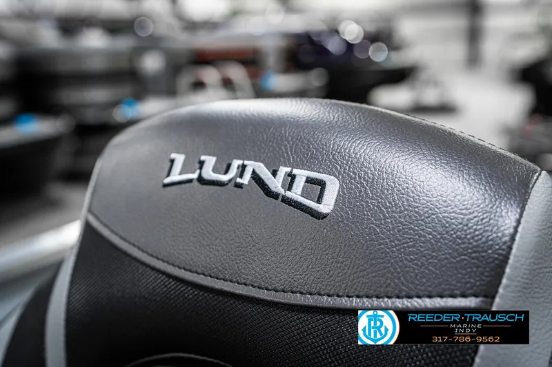 Slide: The Image of 2025 Lund 1600 Fury boat seat with logo, featuring sleek black leather design. - 34