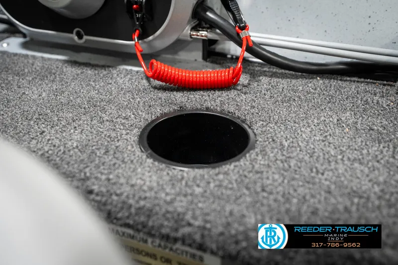 Slide: The Image of 2025 Lund 1600 Fury boat interior with red coiled cable and carpeted surface. - 35