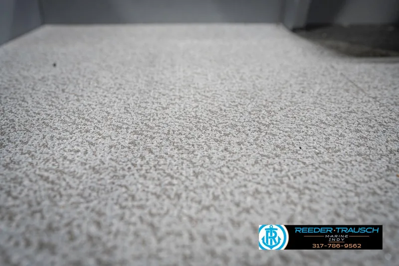 Slide: The Image of Textured flooring of a 2025 Lund 1600 Fury boat, featuring Reeder-Trausch branding. - 36