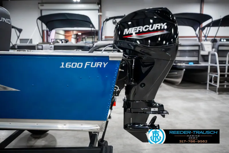 Slide: The Image of 2025 Lund 1600 Fury boat with Mercury outboard motor in showroom. - 37