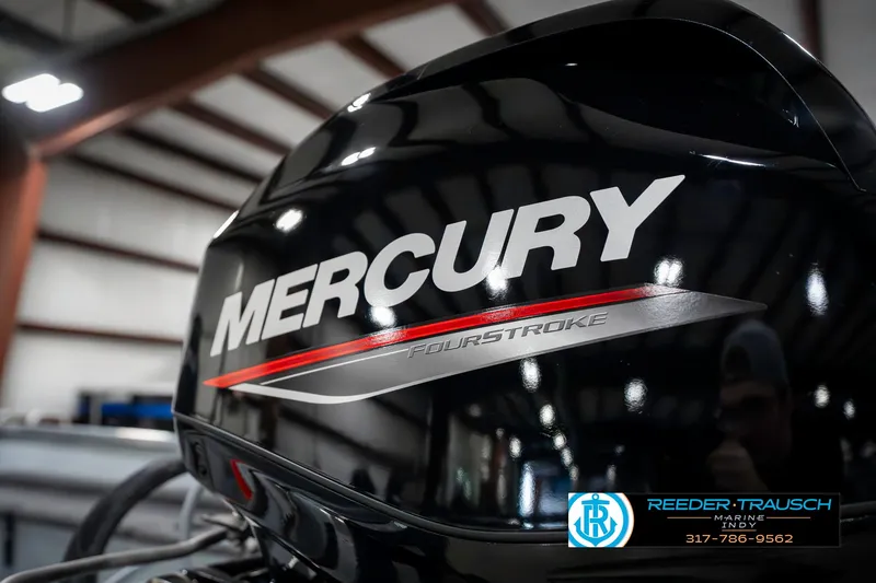 Slide: The Image of Mercury FourStroke engine on 2025 Lund 1600 Fury boat in a showroom. - 38