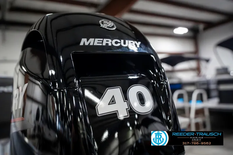 Slide: The Image of 2025 Lund 1600 Fury with Mercury 40 HP outboard engine in showroom setting. - 39