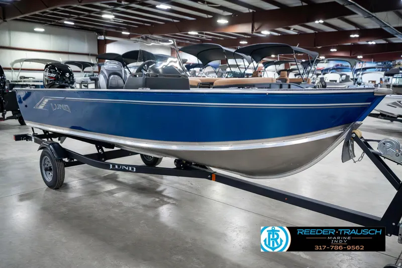 Slide: The Image of 2025 Lund 1600 Fury boat in showroom, blue exterior, on trailer. - 4