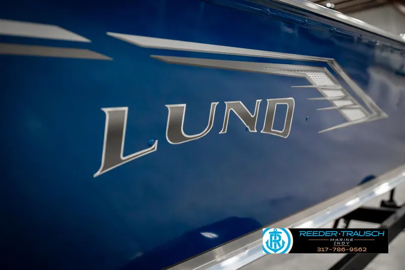 Slide: The Image of 2025 Lund 1600 Fury boat, blue exterior with logo, showcased by Reeder-Trausch Marine. - 41