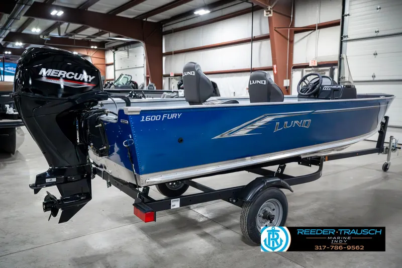 Slide: The Image of 2025 Lund 1600 Fury boat with Mercury engine in showroom, blue exterior. - 6