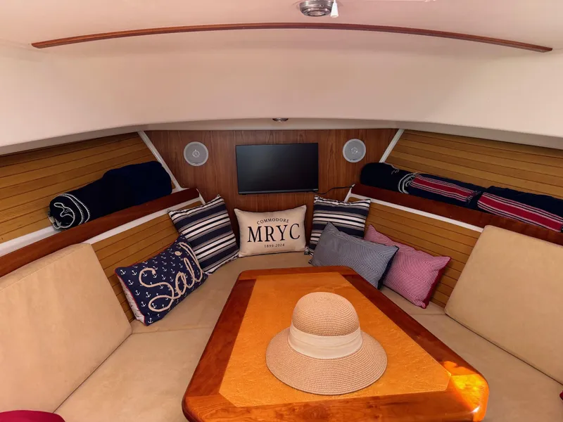 Slide: The Image of Interior of 2007 Back Cove 29 boat with cozy seating and decorative pillows. - 11
