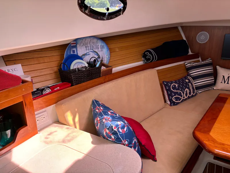 Slide: The Image of Cozy interior of 2007 Back Cove 29 boat with nautical-themed cushions and decor. - 13