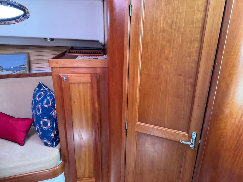 Slide: The Image of Interior of 2007 Back Cove 29 boat with wooden cabinetry and cushioned seating. - 14