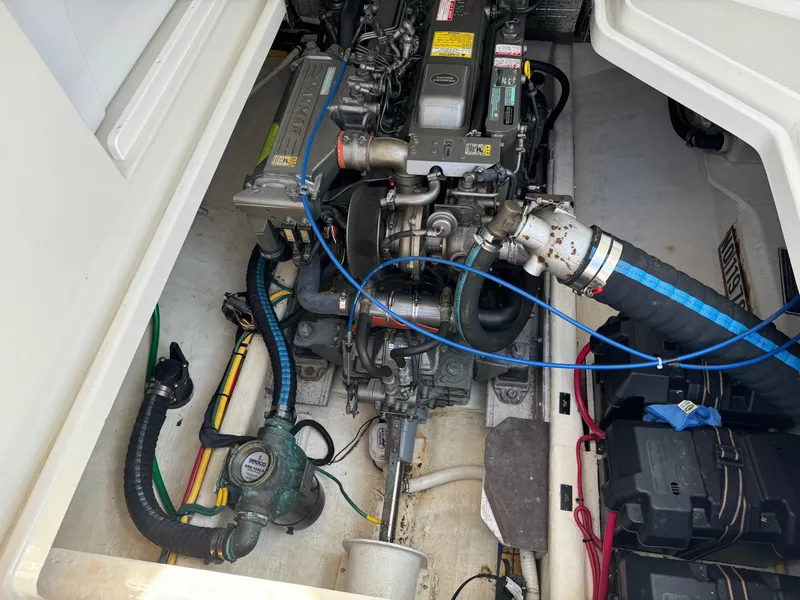Slide: The Image of Engine compartment of a 2007 Back Cove 29 boat, showcasing mechanical components and wiring. - 18
