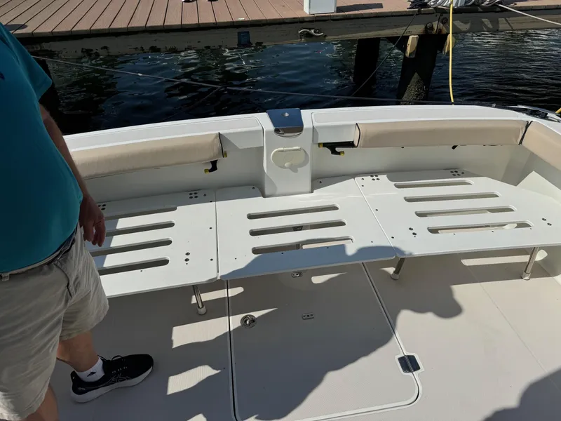 Slide: The Image of 2007 Back Cove 29 boat deck with seating, docked by the water. - 3